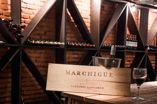 a sign for a wine cellar with a glass of wine at Hacienda Historica Marchigue in Marchihue