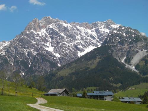 a snow covered mountain with a house in the foreground at Haus Stablerkrämer in Maria Alm am Steinernen Meer