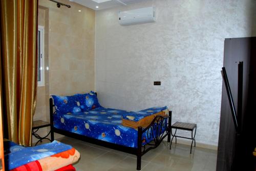 מיטה או מיטות בחדר ב-Appartements Ziad Guéliz
