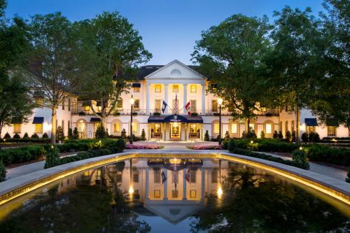a mansion with a pool in front of it at night at Williamsburg Inn, an official Colonial Williamsburg Hotel in Williamsburg