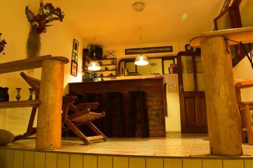 a room with a kitchen with a bar and a table at Bella Vista El Tronco in Sucre