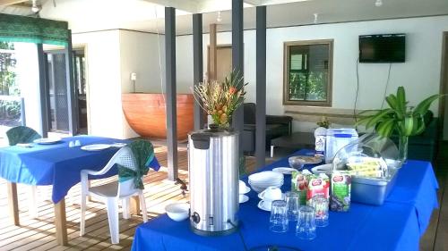 a blue table with a blue table cloth on it at Evis Resort at Nggatirana Island in Halisi