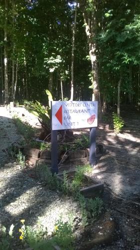 a sign in the middle of a forest at Evis Resort at Nggatirana Island in Halisi