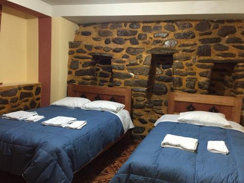Postel nebo postele na pokoji v ubytování Rumi Sonqo Hostel