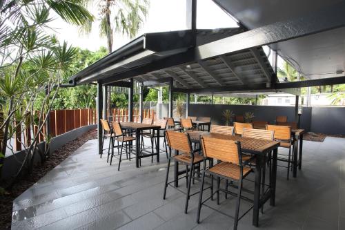 a group of tables and chairs on a patio at Mantra Club Croc in Airlie Beach