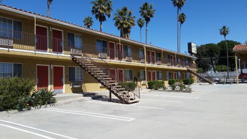 a building with a staircase in a parking lot at Economy Inn Motel in Sylmar