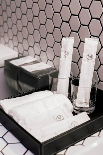 a black tray with towels and two glasses on a counter at M Boutique Kampar in Kampar