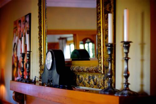 a man sitting in front of a mirror in a room at Hamurana Lodge in Rotorua