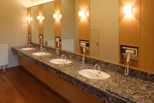 a row of sinks in a public restroom at Shin Furano Prince Hotel in Furano