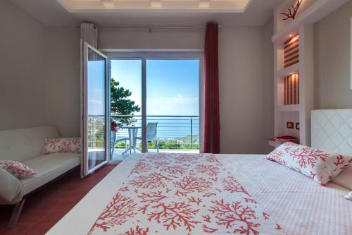 a bedroom with a bed and a view of the ocean at Villa Prestige in Sorrento