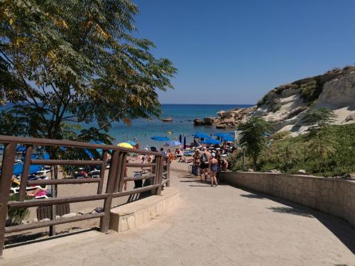 a group of people walking along a beach at Siamese Villa in Paralimni