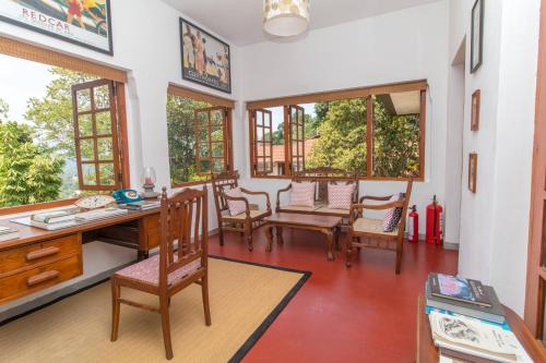 
a living room filled with furniture and a table at The Elephant Stables in Kandy

