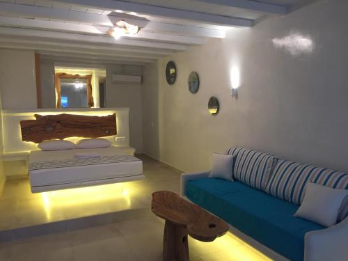 a living room with a couch and a bed at Eternal Suites in Mýkonos City