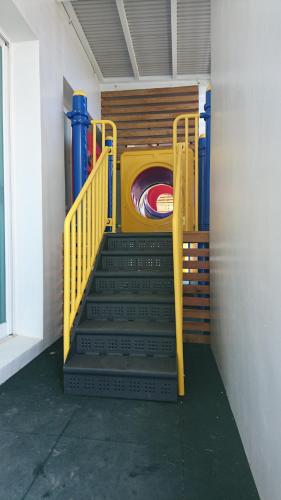 a set of stairs in a building with a machine at Cest La Vie in Eluan