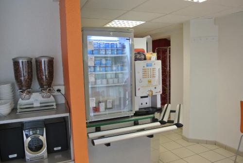 a refrigerator with its door open in a room at Premiere Classe Lyon Sud - Chasse Sur Rhône in Chasse-sur-Rhône
