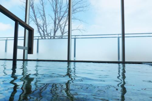an empty gym with a pool of water in a building at Shin Furano Prince Hotel in Furano