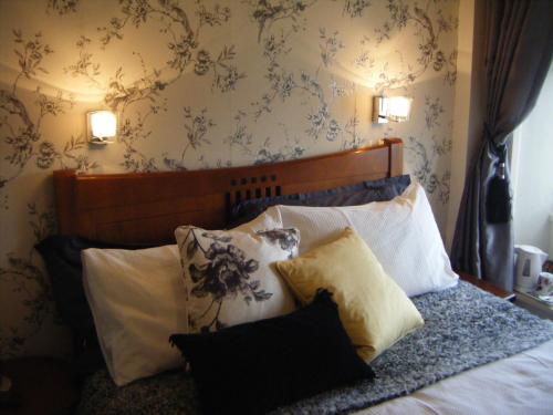 a bedroom with a bed with pillows on it at Pennycroft Guest House in Kettlewell