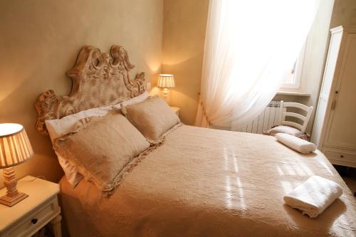 a bedroom with a large bed with a headboard at Luxury Apartment Residence la Fontana in Lucca