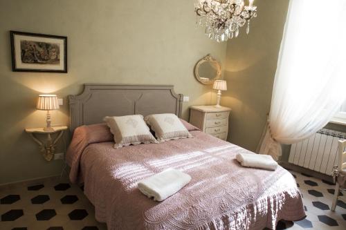 a bedroom with a bed with two towels on it at Luxury Apartment Residence la Fontana in Lucca