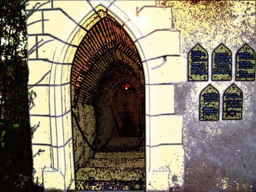 an archway with a staircase in a building with windows at Logis Hôtels Troglododo in Azay-le-Rideau