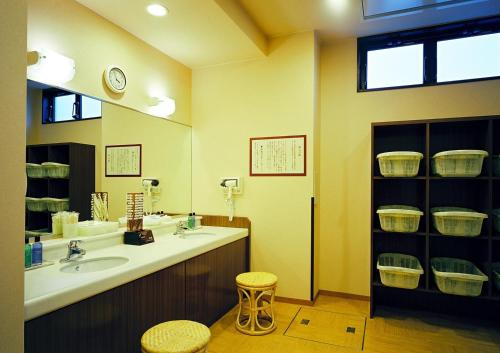 a bathroom with a sink and a mirror at Hotel Route-Inn Mikawa Inter in Hakusan