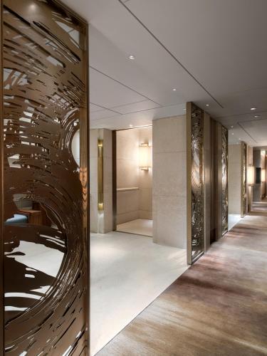 a hallway of a hotel with a large glass wall at Kerry Hotel Hong Kong by Shangri-la in Hong Kong