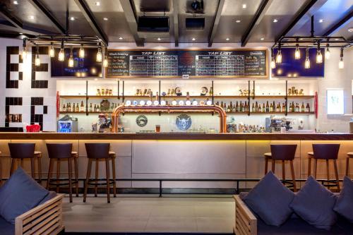 a bar in a restaurant with bar stools at Radisson Blu Plaza Bangkok in Bangkok