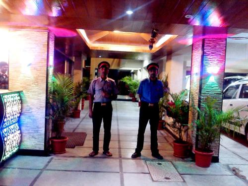 two men standing in front of a building at JS Excellency in Mahabaleshwar