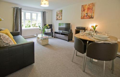 a living room with a table and a couch at Park House in Basingstoke