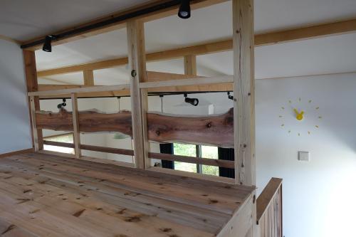 a room with a wooden ceiling with logs on it at Stay Nikko Guesthouse in Nikko