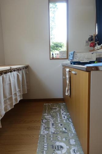 a kitchen with a rug on the floor at Stay Nikko Guesthouse in Nikko