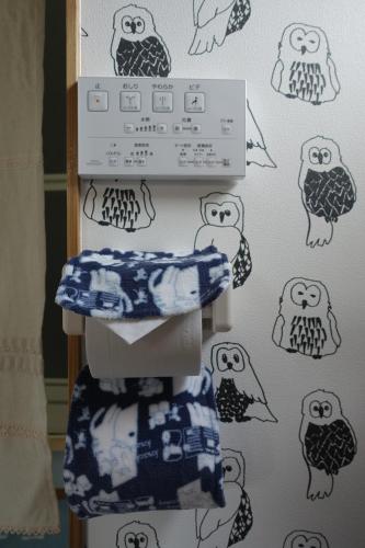 a toilet with drawings of owls on the wall at Stay Nikko Guesthouse in Nikko