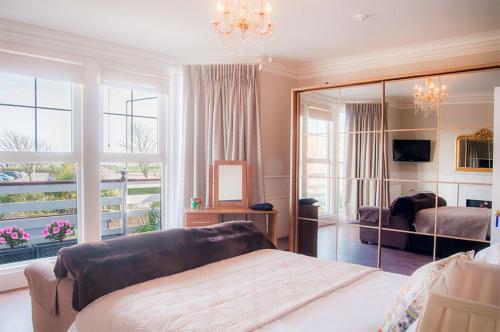 a bedroom with two beds and a large mirror at Number Ninety One in Eastbourne