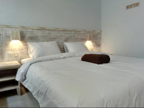 a bedroom with a large white bed with two lights at M BOX Gili Trawangan in Gili Trawangan