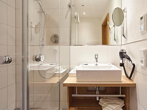 a bathroom with a sink and a shower at Hotel Die Krone - Immenstadt-Stein in Immenstadt im Allgäu