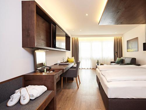 a hotel room with two beds and a desk at Hotel Die Krone - Immenstadt-Stein in Immenstadt im Allgäu