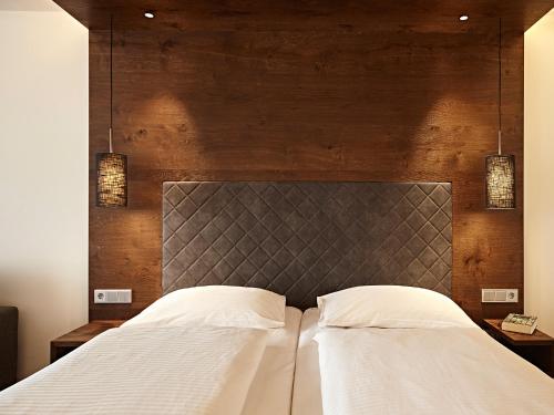 a bedroom with a large bed with two white pillows at Hotel Die Krone - Immenstadt-Stein in Immenstadt im Allgäu