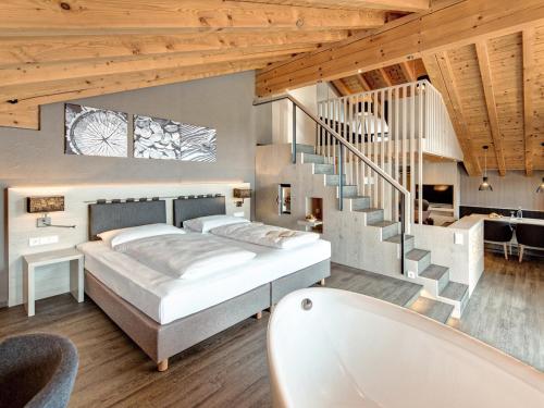 a bedroom with a bed and a staircase at Hotel Die Krone - Immenstadt-Stein in Immenstadt im Allgäu