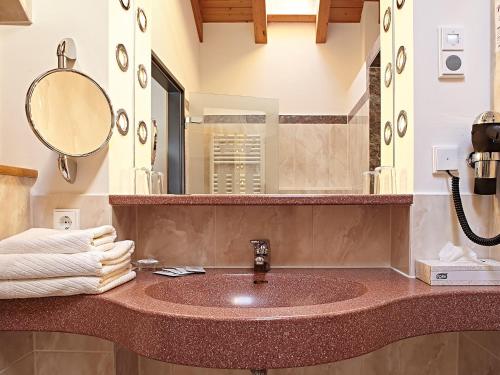 a bathroom with a sink and a mirror at Hotel Die Krone - Immenstadt-Stein in Immenstadt im Allgäu