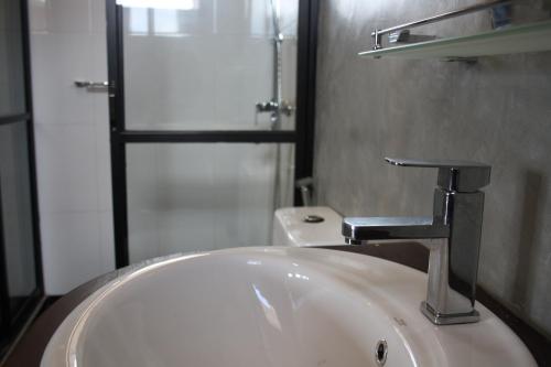 a bathroom with a sink and a faucet at Ella Repose in Ella