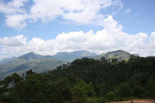 a view of a mountain range with trees and clouds at Ella Repose in Ella
