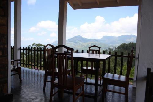a table and chairs on a balcony with a view at Ella Repose in Ella