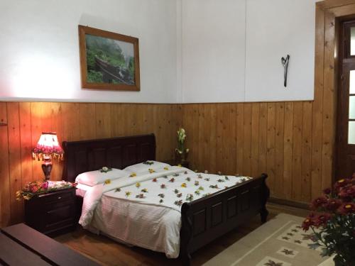 a bedroom with a bed in a room with wooden walls at The Trevene Hotel in Nuwara Eliya