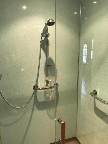a shower in a bathroom with a glass wall at Hillford House in Stirling