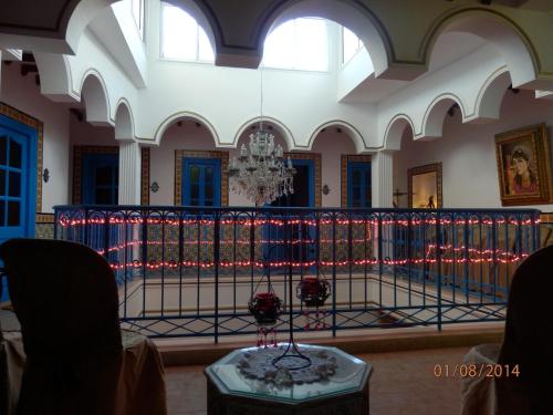 a wrought iron fence in a room with christmas lights at Dar El Kasba Riad Guest House in Bizerte