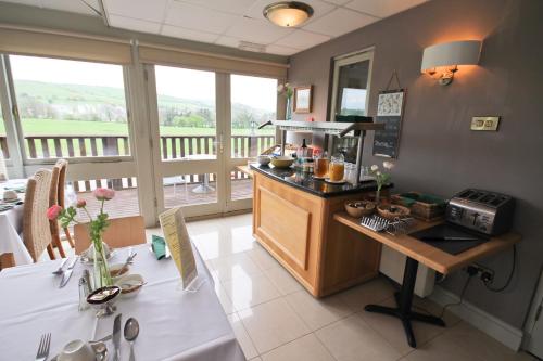 a kitchen with a counter with a coffee maker on it at Llety Ceiro Guesthouse in Aberystwyth
