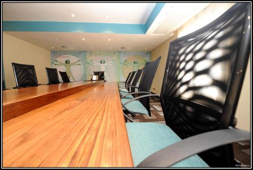 a conference room with a long table and chairs at Metcourt at Emperors Palace in Kempton Park