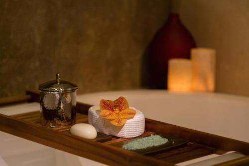 a tray with a towel and a flower on it at Raffles Jakarta in Jakarta