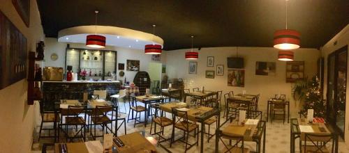 a restaurant with tables and chairs in a room at For Rest Aparthotel in St Paul's Bay