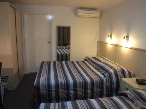 
a hotel room with a bed and a television at Streaky Bay Hotel Motel in Streaky Bay
